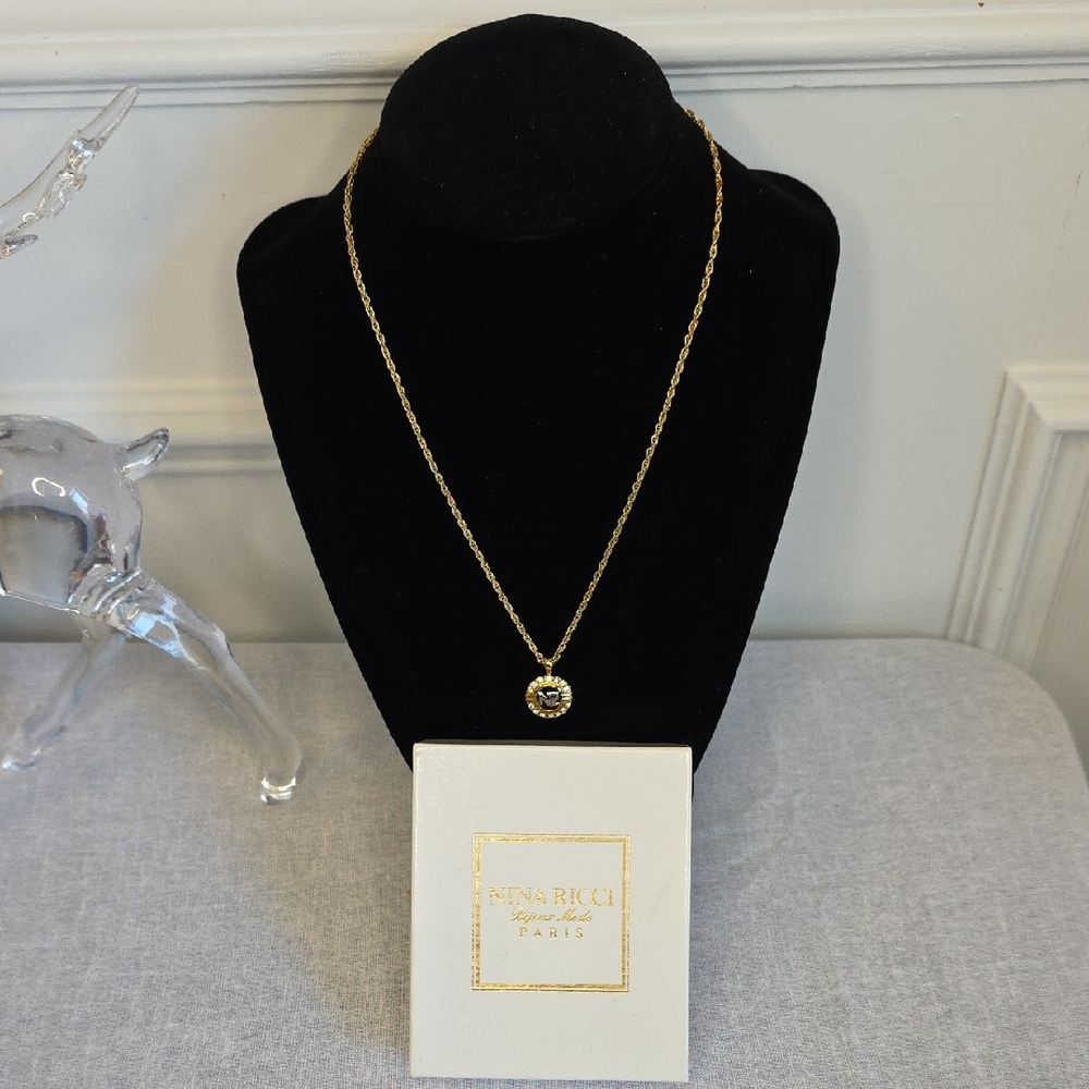Nina Ricci Elegant Gold Necklace with Crystal Encrusted Circular Pendant